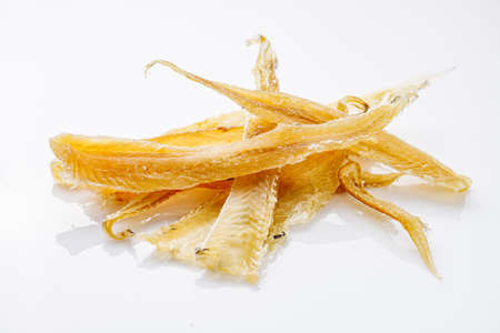 dried fish snack on a white acrylic background.