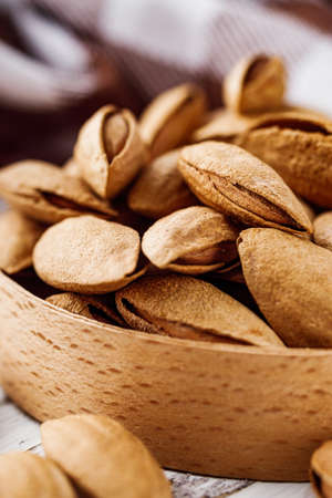 fresh almonds in shell on a white background.