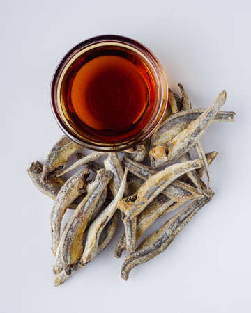 fragrant fish sauce on a white acrylic background.