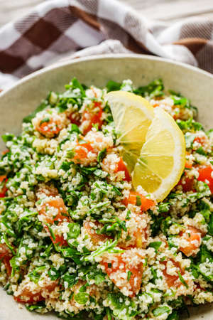 arabic salad tabbouleh on a rustic wooden background.の写真素材