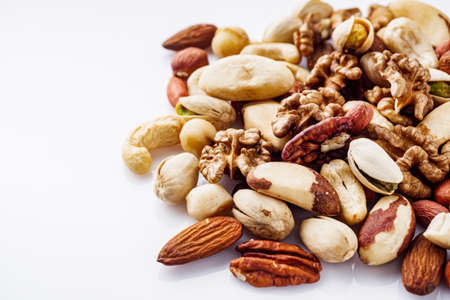 set of different nuts on a white acrylic background.の写真素材