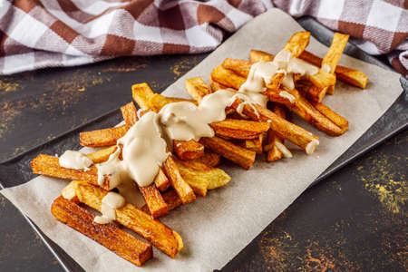 golden french fries on a dark rustic background.
