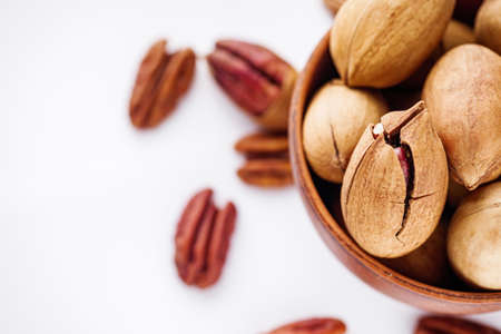 delicious fresh pecans on a white acrylic background.の写真素材
