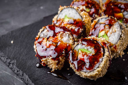 delicious sushi rolls on a black stone background.の写真素材