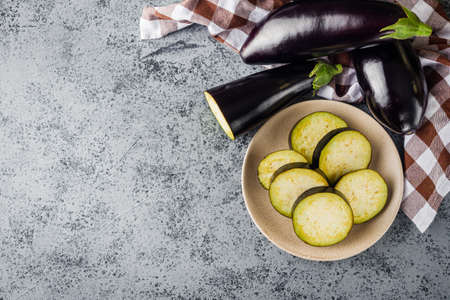 fresh natural eggplant on a gray stone background.