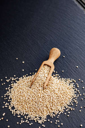 white quinoa seeds on a dark rustic background.の写真素材