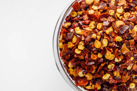 spicy chili flakes on a white background.