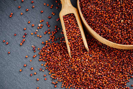 red quinoa seeds on a dark rustic background.の写真素材