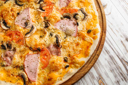delicious hot traditional italian pizza on a white wooden rustic background.の写真素材