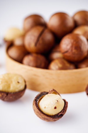 fresh macadamia nuts on a white acrylic background.の写真素材