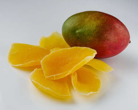 delicious dried mango on a white acrylic background.の写真素材
