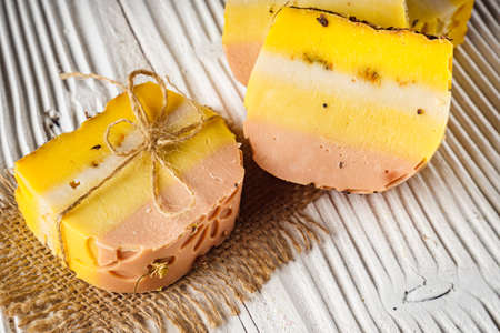 handmade soap on a white wooden rustic background.の写真素材