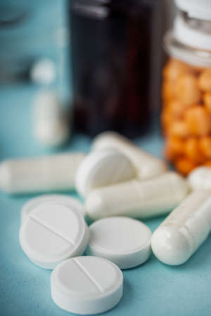 various medicines on a blue paper background.