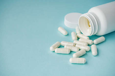 various medicines on a blue paper background.