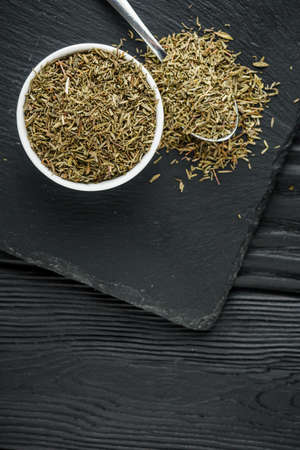 fragrant dried thyme on a dark stone background.の写真素材