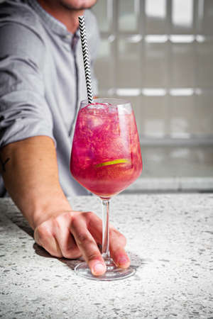 bright colored alcoholic cocktail on a bar background.の写真素材