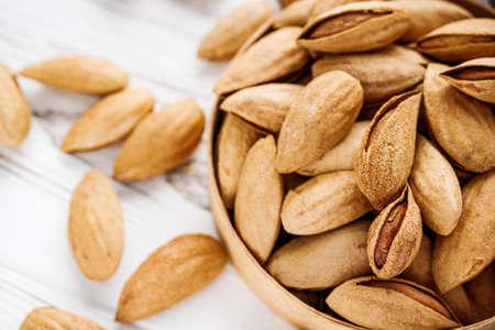 fresh almonds in shell on a white background.