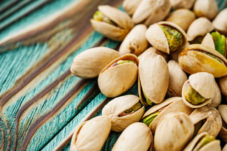 fresh salted pistachios on a wooden rustic background.の写真素材