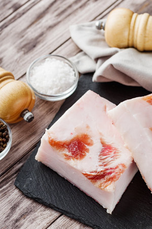 piece of lard on a wooden rustic background.の写真素材