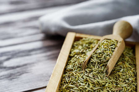 fragrant dried rosemary on a wooden rustic background.