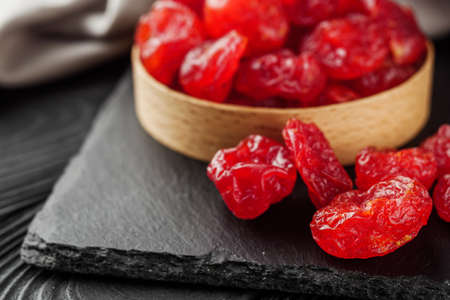 dogwood dried berry on a black rustic wooden background.