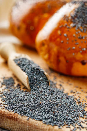 bun with poppy seeds on a white wooden rustic background.の写真素材