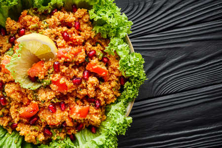 traditional turkish salad kisir on black wooden rustic background.の写真素材