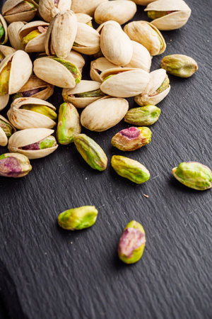 fresh salted pistachios on a black stone wooden rustic background.の写真素材