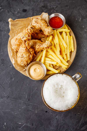 crispy deep-fried chicken drumsticks on a black background.の写真素材