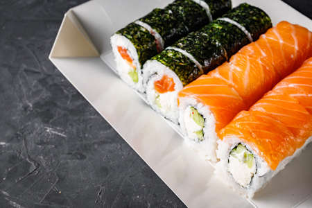 delicious sushi rolls in a delivery box on a black background.の写真素材