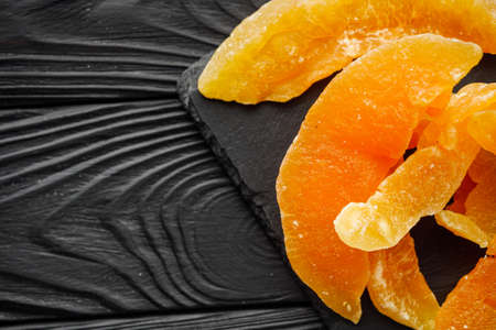 delicious dried melon on a black rustic wooden background.の写真素材