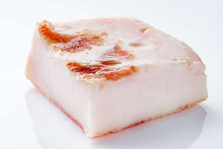 piece of lard on a white acrylic background.の写真素材