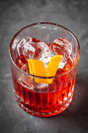 bright colored alcoholic cocktail on a black stone background.の写真素材