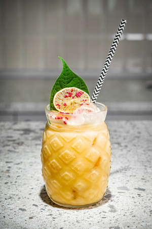 bright colored alcoholic cocktail on a bar background.