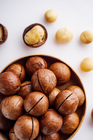 fresh macadamia nuts on a white acrylic background.の写真素材
