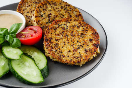 Quinoa cutlet with vegetables on a white background.の写真素材