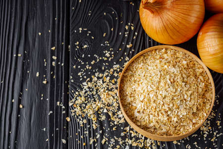 dried onions on a black wooden rustic background.の写真素材