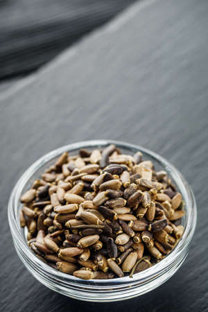 milk thistle seeds on a black wooden rustic background.の写真素材