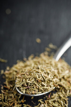 fragrant dried thyme on a dark stone background.の写真素材
