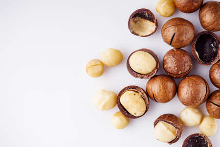 fresh macadamia nuts on a white acrylic background.の写真素材