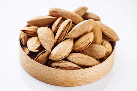 fresh almonds in shell on a white background.