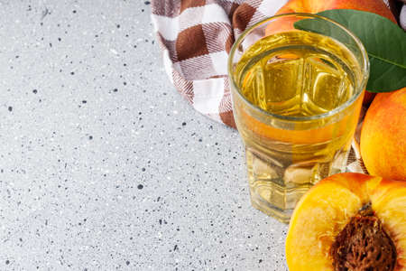 fresh peach cider on a gray stone background.の写真素材