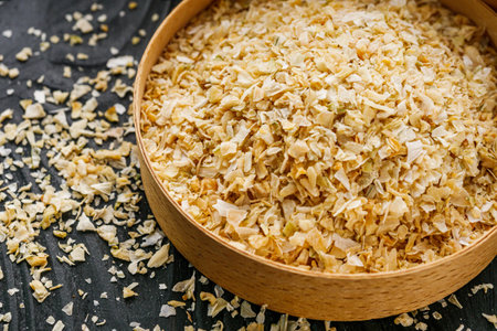 dried onions on a black wooden rustic background.