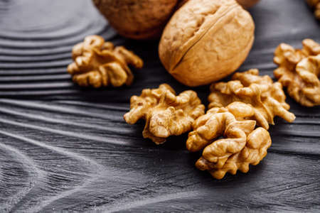 dried walnuts on a black rustic wooden background.の写真素材
