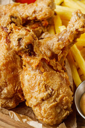 crispy deep-fried chicken drumsticks on a black background.の写真素材