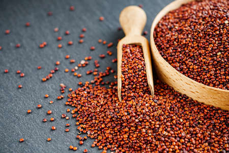 red quinoa seeds on a dark rustic background.の写真素材