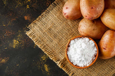 potato starch on a dark rustic background.の写真素材