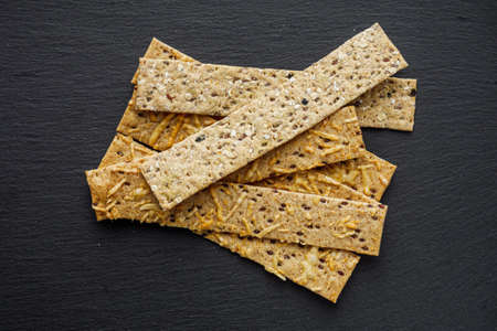 diet crispy bread on a black stone background.