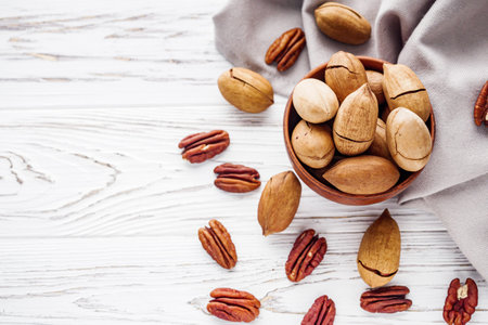 delicious fresh pecans on a white wooden rustic background.の写真素材