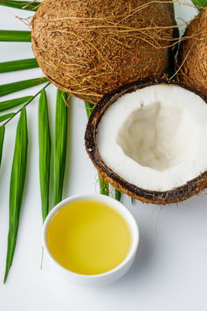 fresh natural coconut and oil on white acrylic background.